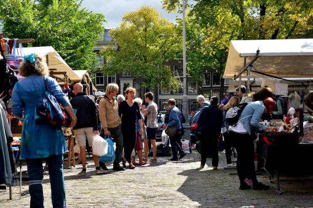 Daily Life in Amsterdam Amsterdam, Netherlands - September 1, 2014; Locals and tourists explore a market in the Jordaan section of Amsterdam, the Netherlands, on September 1, 2014. jordaan amsterdam stock pictures, royalty-free photos & images