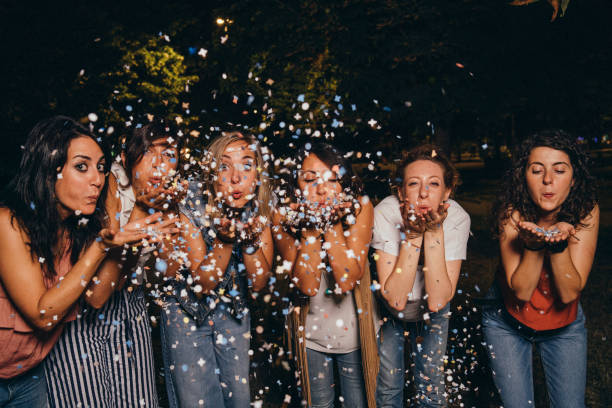 istock Friends having fun together with confetti at a party 1027258200