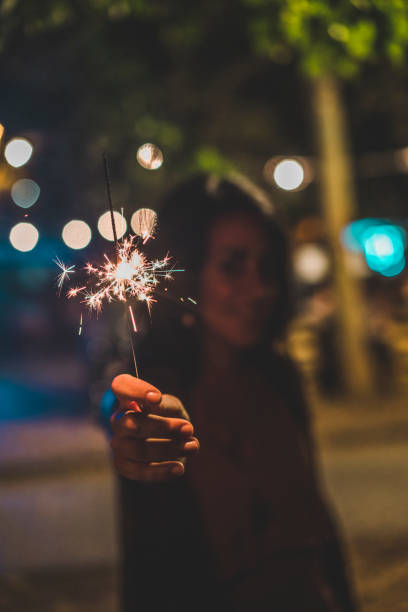 istock Holding a sparkler to celebrate 1027258230