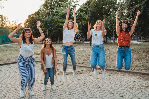 istock Friends having fun together with confetti at a party 1027258344