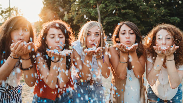 istock Friends having fun together with confetti at a party 1027258350