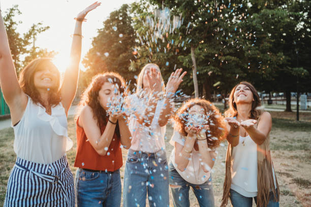 istock Friends having fun together with confetti at a party 1027258368