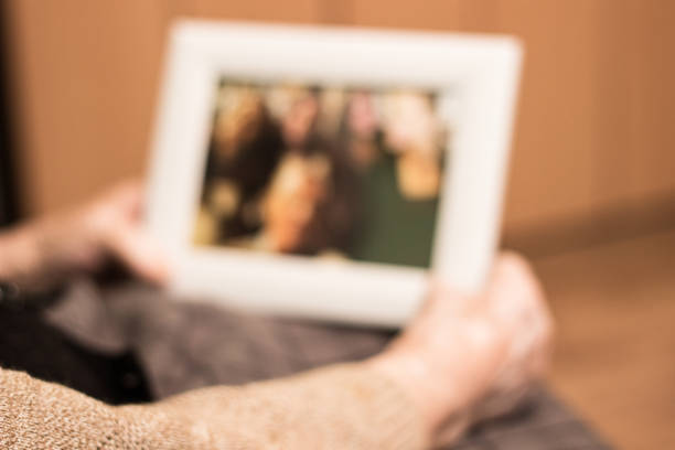 istock Elderly woman holding a picture frame and watching picture 1027262286