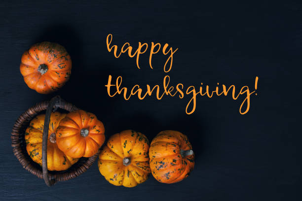 istock Happy Thanksgiving greeting card with orange pumpkins 1027272704