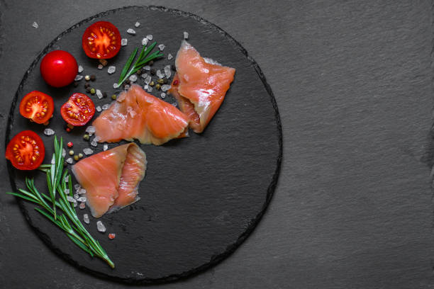 istock Fresh fish. Salmon fillet on black background. . food background. top view 1027280258