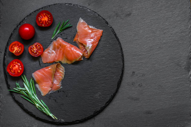 istock Fresh fish. Salmon fillet on black background. . food background. top view 1027280268