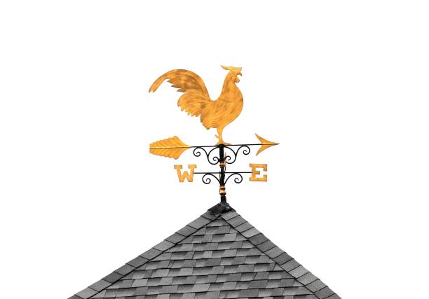 Golden weather vane chicken on roof isolated on white background stock photo