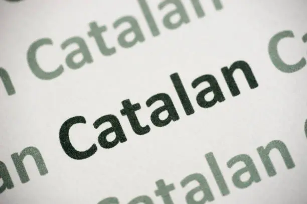 Photo of word Catalan language printed on paper macro