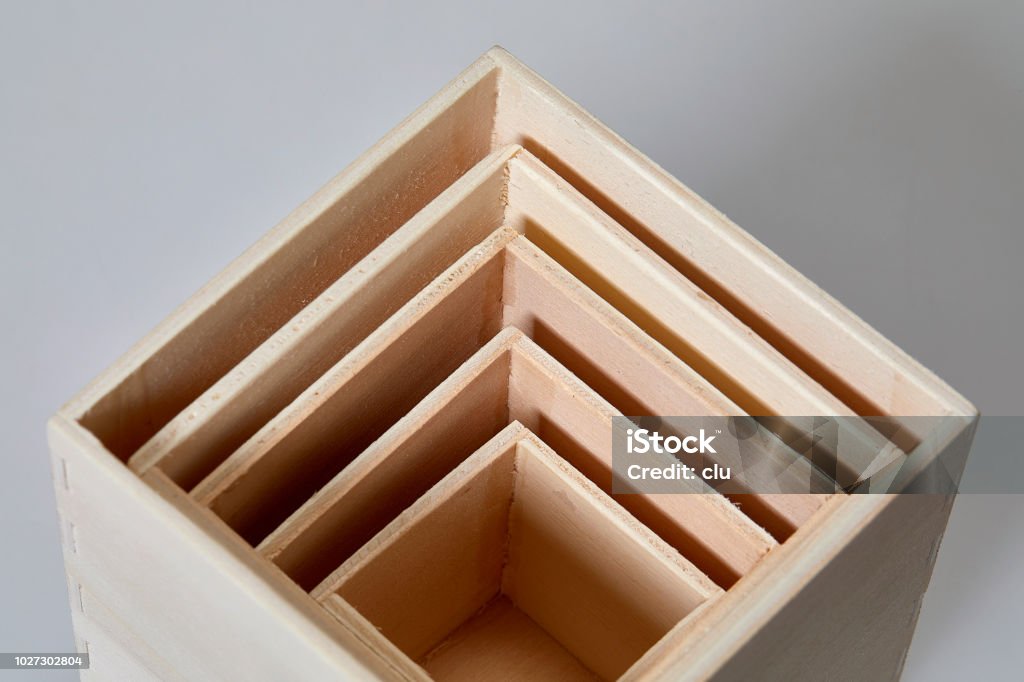 Stack of wooden cubes on white background from above Stack of wooden cubes on white background Russian Nesting Doll Stock Photo