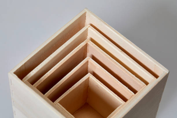 stack of wooden cubes on white background from above - russian nesting doll fotos imagens e fotografias de stock