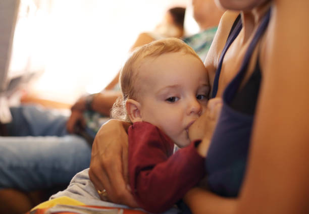 istock Baby boy sleeping on mother's lap in an airplane 1027311576
