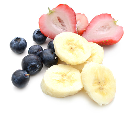 Strawberry kiwi, banana and blueberry slice isolated on white