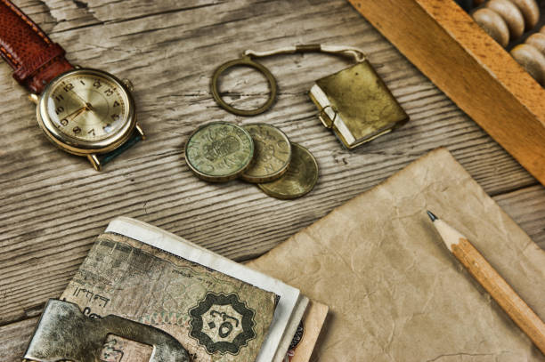 istock Old notes and coins and abacus on a wooden table 1027321388