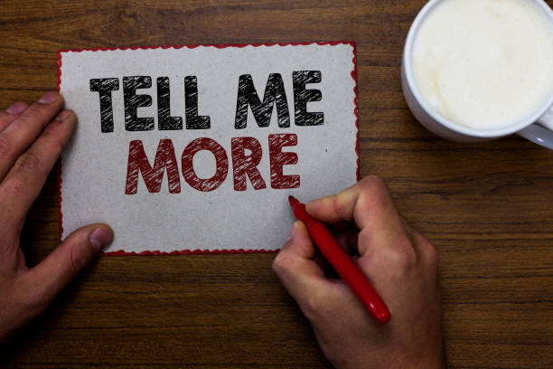 istock Word writing text Tell Me More. Business concept for A call to start a conversation Sharing more knowledge Man holding marker communicating ideas piece paper wooden table cup coffee 1027321776