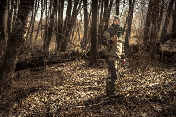 istock Hunter man autumn forest with transmitter during hunting season 1027321972