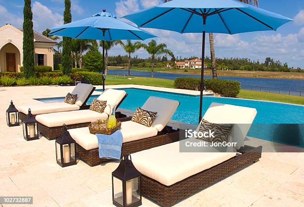 Tropical Poolside Recliners And Umbrellas Stock Photo - Download Image Now - Color Image, Drinking Glass, Horizontal