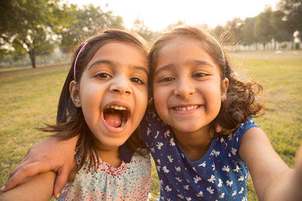 Little girl taking a selfie - Stock image