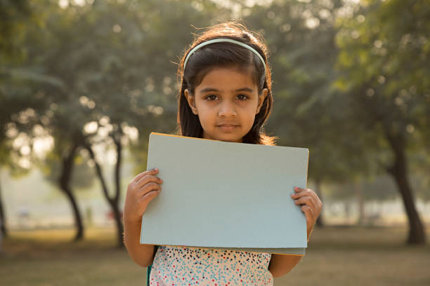 istock Little Girl holding blank banner - Stock image 1027335896