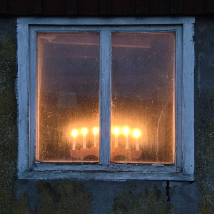 Advent candelabra in an old window, swedish traditional
