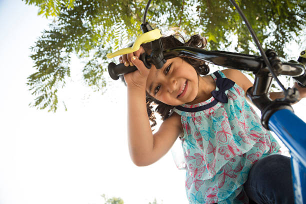 istock Girl Riding a Bike - Stock image 1027339570