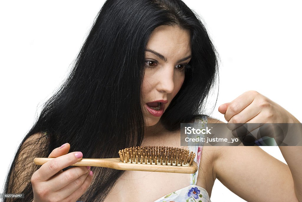 Woman losing hair on hairbrush  Hair Loss Stock Photo
