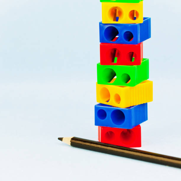 istock stack of multicoloured pencil sharpeners and black pencil 1027347766
