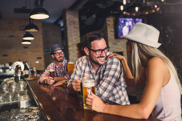 istock Young people drinking beer and laughing together 1027350500