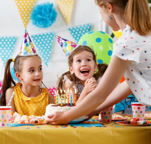 istock children's birthday. happy kids with cake 1027350616