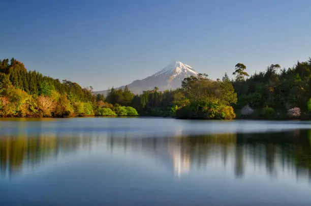 Reflection of Mount Taranaki also known as Mt. Egmont in lake, New Zealand