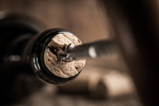 istock Corkscrew screwed into the cork in the bottle of wine. 1027356060