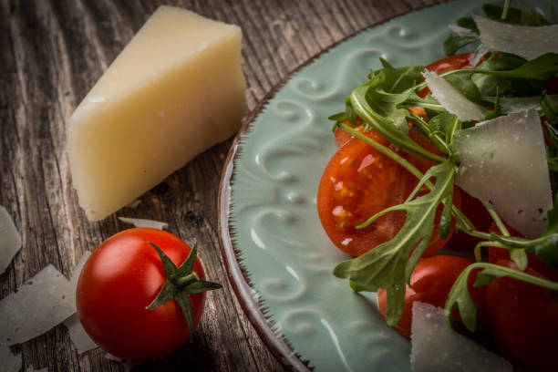 Salad with arugula, cherry tomatoes, parmesan and shallot