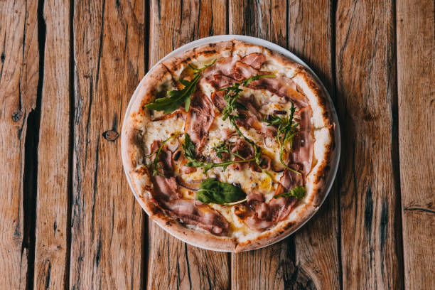 istock Overhead pizza carbonara on rustic wooden table 1027359104