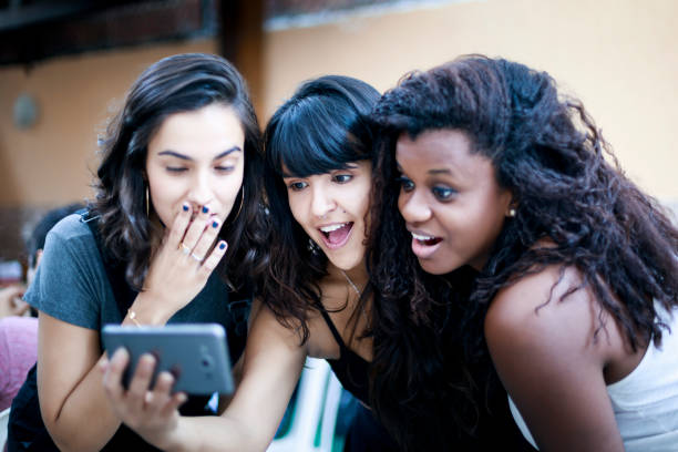 istock Three young woman gossiping on the internet 1027362320