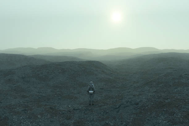istock Astronaut standing on rocky alien landscape 1027369560