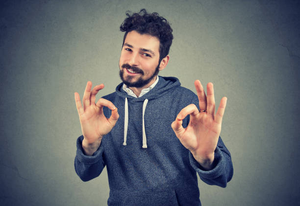 istock young handsome confident man showing ok sign 1027374242