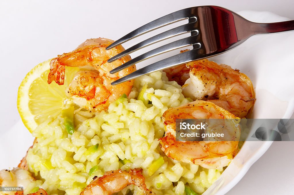 Risotto with fried prawns and avocado  Arrangement Stock Photo