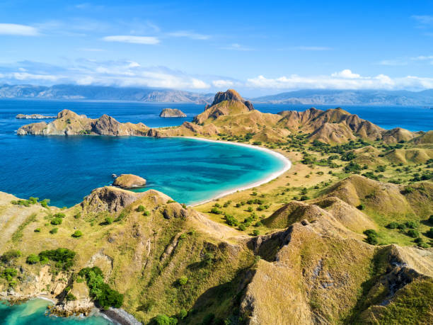 Pulau Padar Aerial view of a small bay and hills on Pulau Padar island in between Komodo and Rinca Islands near Labuan Bajo in Indonesia. pulau komodo stock pictures, royalty-free photos & images