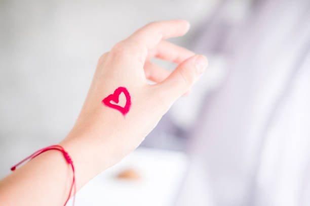 istock Heart with lipstick on woman's hand 1027385248