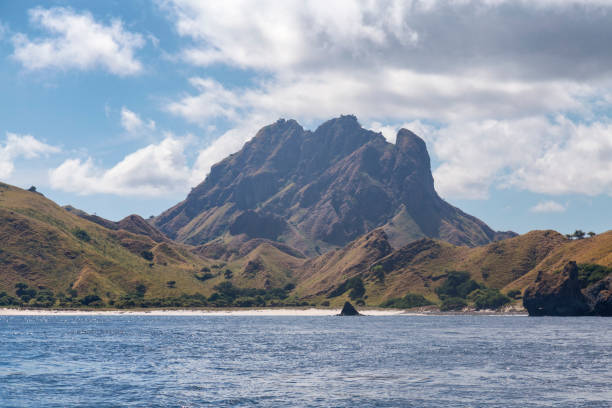 Dramatic Mountain and Beach Scenic mountain on Pulau Padar island in the Komodo National Park. pulau komodo stock pictures, royalty-free photos & images