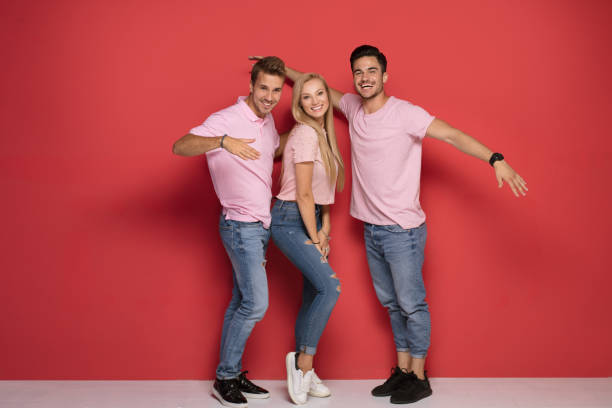 istock One blonde girl with two handsome men. 1027390726