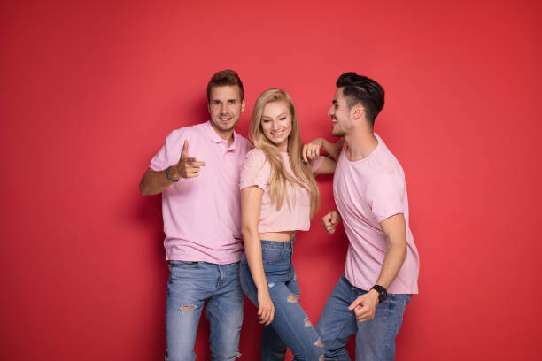 istock One blonde girl with two handsome men. 1027390754