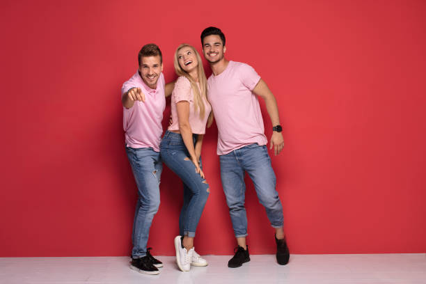 istock One blonde girl with two handsome men. 1027390768