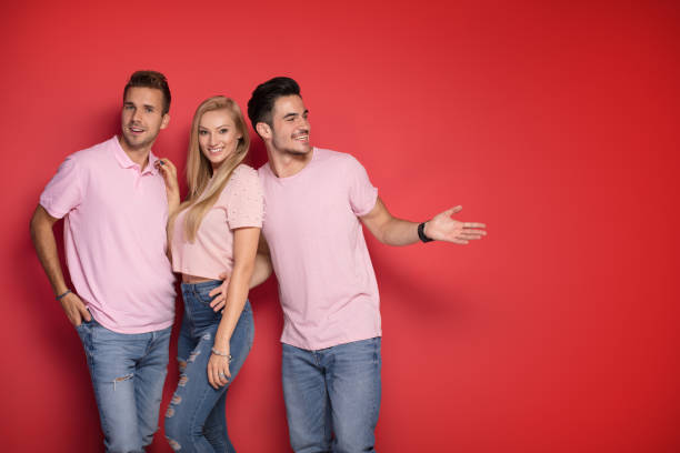 istock One blonde girl with two handsome men. 1027390798
