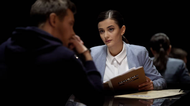 istock Beautiful interrogator meeting arrested man, investigating crime, mistrust 1027397096