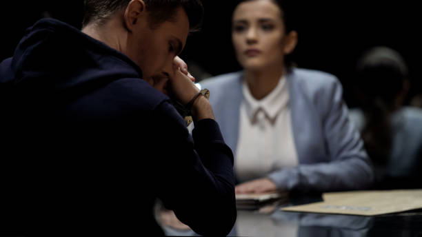 istock Law enforcement officer interrogating murder suspect, arrested male feels guilty 1027397102