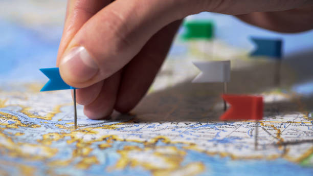 Hand making pin mark on Canada map, travel destination, company branch office