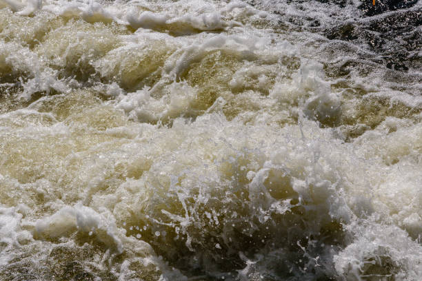 istock flow of water and spray from a stone 1027397548