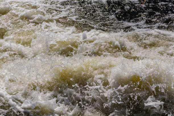 istock flow of water and spray from a stone 1027397604