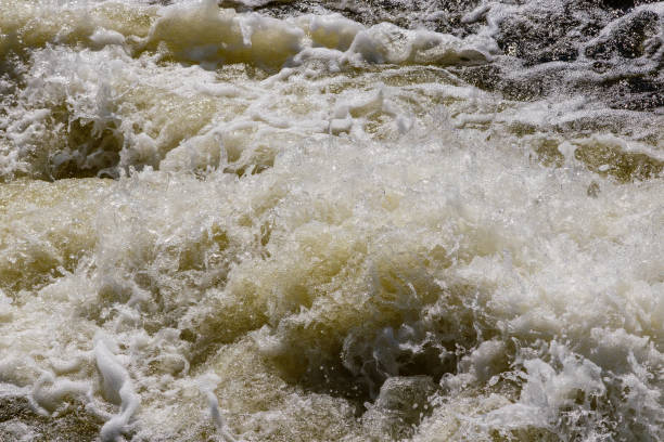 istock flow of water and spray from a stone 1027399800