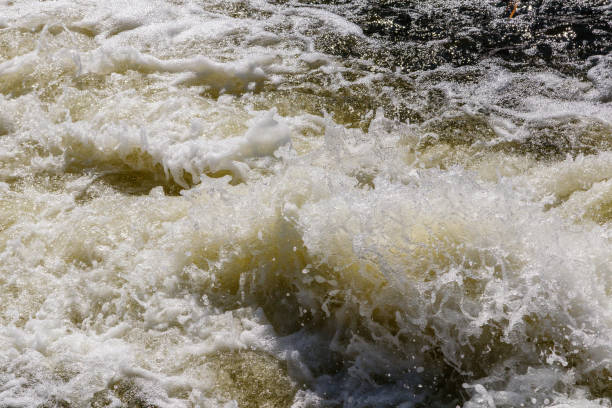 istock flow of water and spray from a stone 1027400318